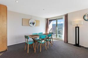 a dining room with a table and chairs and a window at Apartment in the heart of the city in Christchurch
