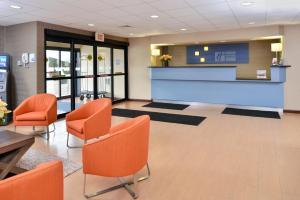 a lobby with orange chairs and a waiting room at Best Western North Attleboro - Providence Beltway in North Attleboro