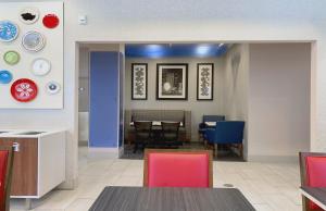 a kitchen and dining room with a table and chairs at Holiday Inn Express Hotel & Suites Minneapolis-Downtown Convention Center by IHG in Minneapolis +34 photos