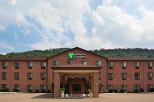 a large red brick building with a sign on it at Holiday Inn Express - Newell-Chester WV, an IHG Hotel in Newell