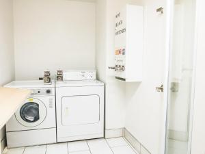 a white laundry room with a washer and dryer at Holiday Inn Express Pendleton by IHG in Pendleton