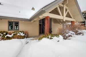 a house with snow in front of it at Silver Bow 65 in Big Sky