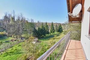a balcony with a view of a forest at Holiday Home Lana in Fužine