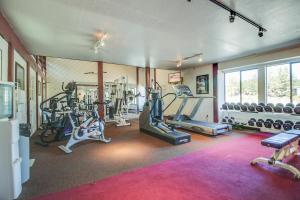 a gym with several treadmills and machines in a room at The Summit 276 in Mammoth Lakes
