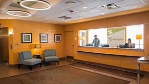 a waiting room with two people at a reception counter at Holiday Inn St. Paul Downtown, an IHG Hotel in Saint Paul