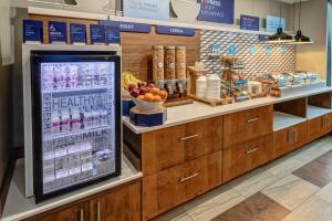 a grocery store display with a drink machine in a store at Holiday Inn Express Hotel & Suites Memphis Southwind, an IHG Hotel in Memphis