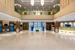 a lobby of a hotel with a large white tile floor at Holiday Inn Express Shangdi Beijing, an IHG Hotel in Beijing