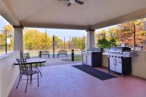 a patio with a grill and a table and chairs at Staybridge Suites Oklahoma City, an IHG Hotel in Oklahoma City