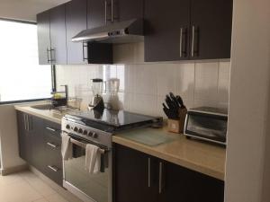 a kitchen with a stove and a counter top at Moderna Suite Privada Alberca Av B Quintana 29C in Mendiola