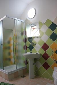 a bathroom with a sink and a shower at Hanul Kassay in Frumoasa