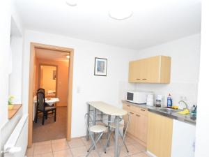 a kitchen with a counter and a table and chairs at Charming Apartment, Harz Region in Meisdorf