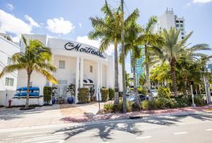 
a large white truck parked in front of a palm tree at Oceanside Hotel and Suites in Miami Beach
