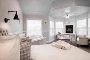 a large bedroom with a bed and a bath tub at Hounds Tooth Inn in Oakhurst