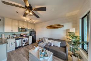 a living room with a couch and a ceiling fan at Pink Pineapple in Hilton Head Island