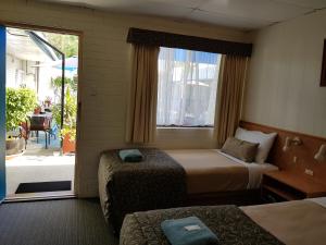 Postel nebo postele na pokoji v ubytování Peppercorn Motel