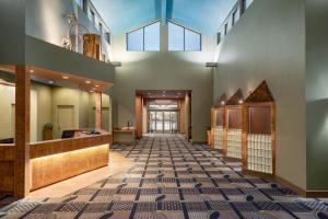 a hallway of a building with a tile floor at Royal Hotel West Edmonton, Trademark Collection by Wyndham in Edmonton