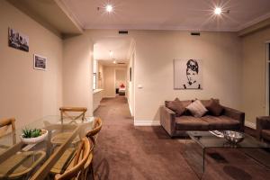 a living room with a couch and a table at Flinders Landing Apartments in Melbourne