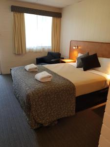 Postel nebo postele na pokoji v ubytování Peppercorn Motel