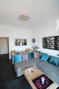 a living room with a couch and a table at Kavala marina view studio in Kavala
