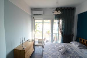 a bedroom with a bed with two pillows on it at Kavala marina view studio in Kavala