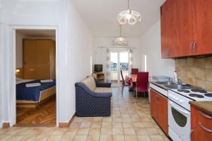 a kitchen and a living room with a bed at Apartments Zorka in Kampor