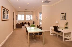 a living room with a table and a couch at Flinders Landing Apartments in Melbourne