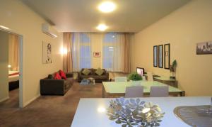 a living room with a couch and a table at Flinders Landing Apartments in Melbourne