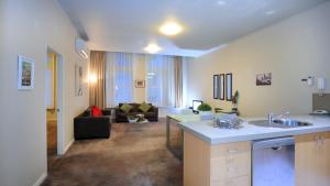 a large living room with a kitchen and a living room at Flinders Landing Apartments in Melbourne