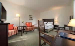 une chambre d'hôtel avec un lit et un salon dans l'établissement Best Western Soibelmanns Lutherstadt Wittenberg, à Wittemberg