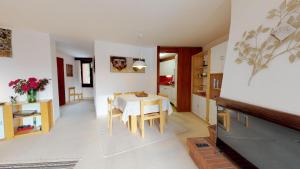 a kitchen and dining room with a table and chairs at Abitaziun Quadratscha 22 - Samedan in Samedan