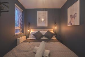 a bedroom with a bed with two pillows and a window at Yellow Hive Boutique Stay Apt 2 in Belfast