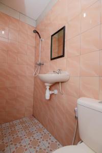 a bathroom with a sink and a toilet at Hotel Olympic Semarang by Sajiwa in Semarang