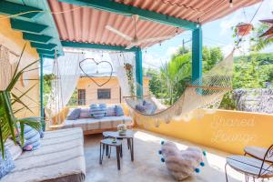 a room with a hammock and a bed at Sayulita Boutique Suites - Pool Access, Kitchen, Walk to Beach in Sayulita