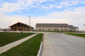 a large building with a road in front of it at Cobblestone Inn & Suites - Lake View in Lake View
