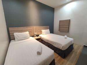 Postel nebo postele na pokoji v ubytování T Hotel Tandop