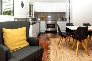 a kitchen with a couch and a table and chairs at The House at No 1 in Havelock North +10 photos