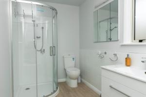 a bathroom with a shower and a toilet and a sink at The House at No 1 in Havelock North