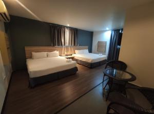 מיטה או מיטות בחדר ב-T Hotel Tandop