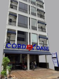 a building with a sign on the side of it at Cordex Oase Pekanbaru in Pekanbaru