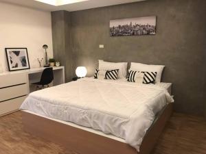 Postel nebo postele na pokoji v ubytování The Peem Hotel