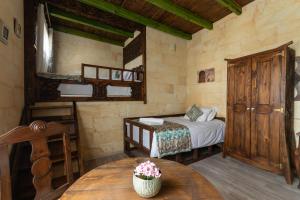 a bedroom with a bed and a table in a room at Cozy Rooms Goreme in Goreme