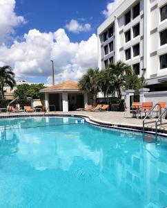 a large blue swimming pool in front of a hotel at Holiday Inn Express Hotel & Suites Miami - Hialeah by IHG in Hialeah