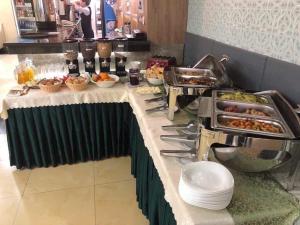 a buffet with food on a table in a restaurant at Guide Hotel in Ulaanbaatar