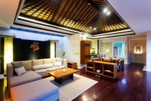 a living room with a couch and a table at Kedonganan Beach Villas in Jimbaran