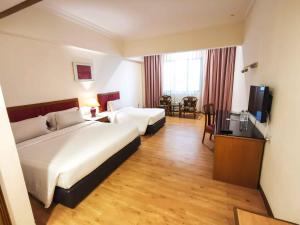 Rúm í herbergi á Crystal Crown Hotel Harbour View, Port Klang