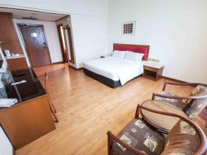 Rúm í herbergi á Crystal Crown Hotel Harbour View, Port Klang