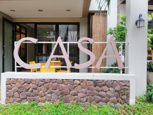 a sign for a cafe in front of a building at Casa Coron Hotel in Coron