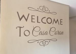 a sign for a welcome to casa ciao at Casa Coron Hotel in Coron