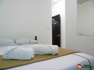 Säng eller sängar i ett rum på Hotel El Descanso