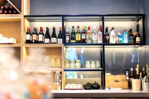 a shelf filled with lots of bottles of alcohol at Campanile Shanghai Huaihai in Shanghai